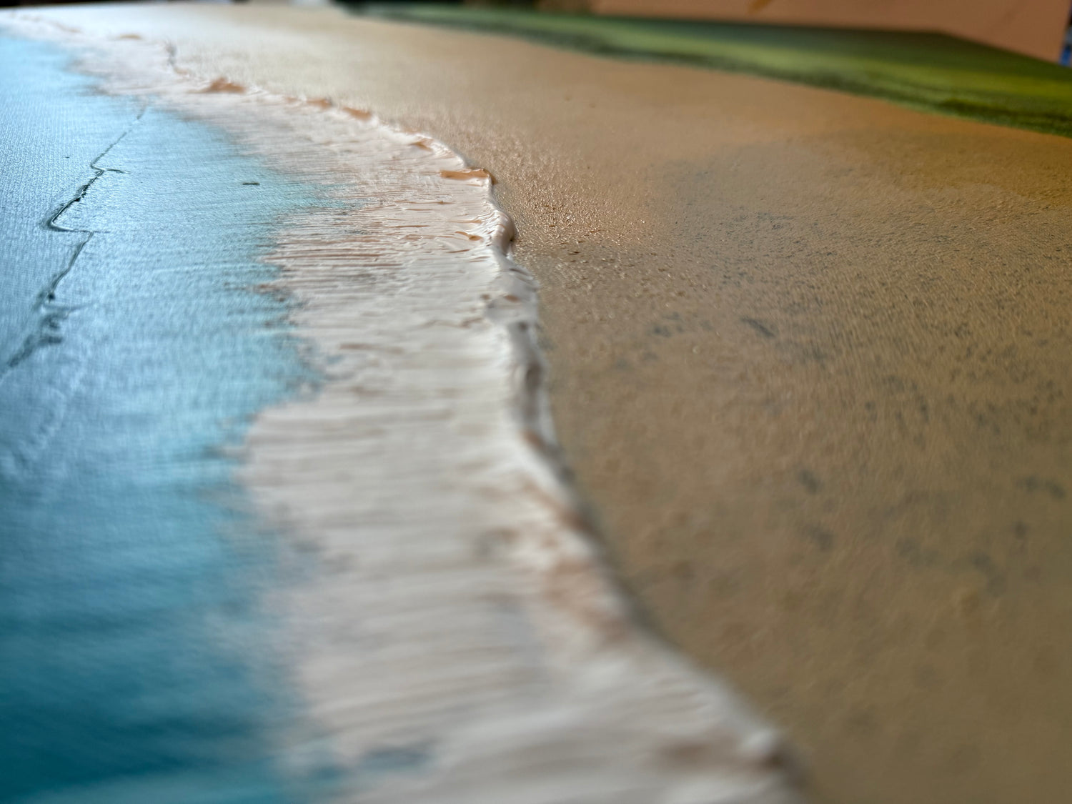 Close-up of a beach with sand and water meeting.