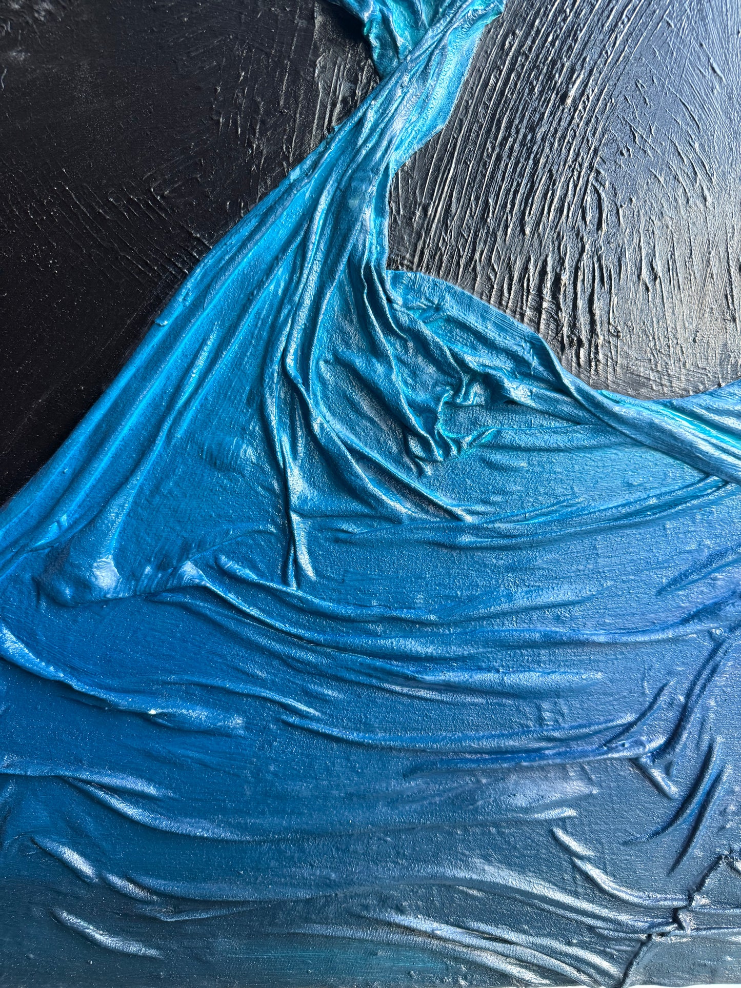 Close-up of textured blue paint on a black background