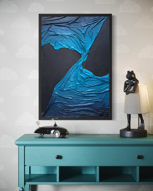 Framed abstract blue artwork on a wall above a teal console table with decorative items. Twist By Michel L'Artiste