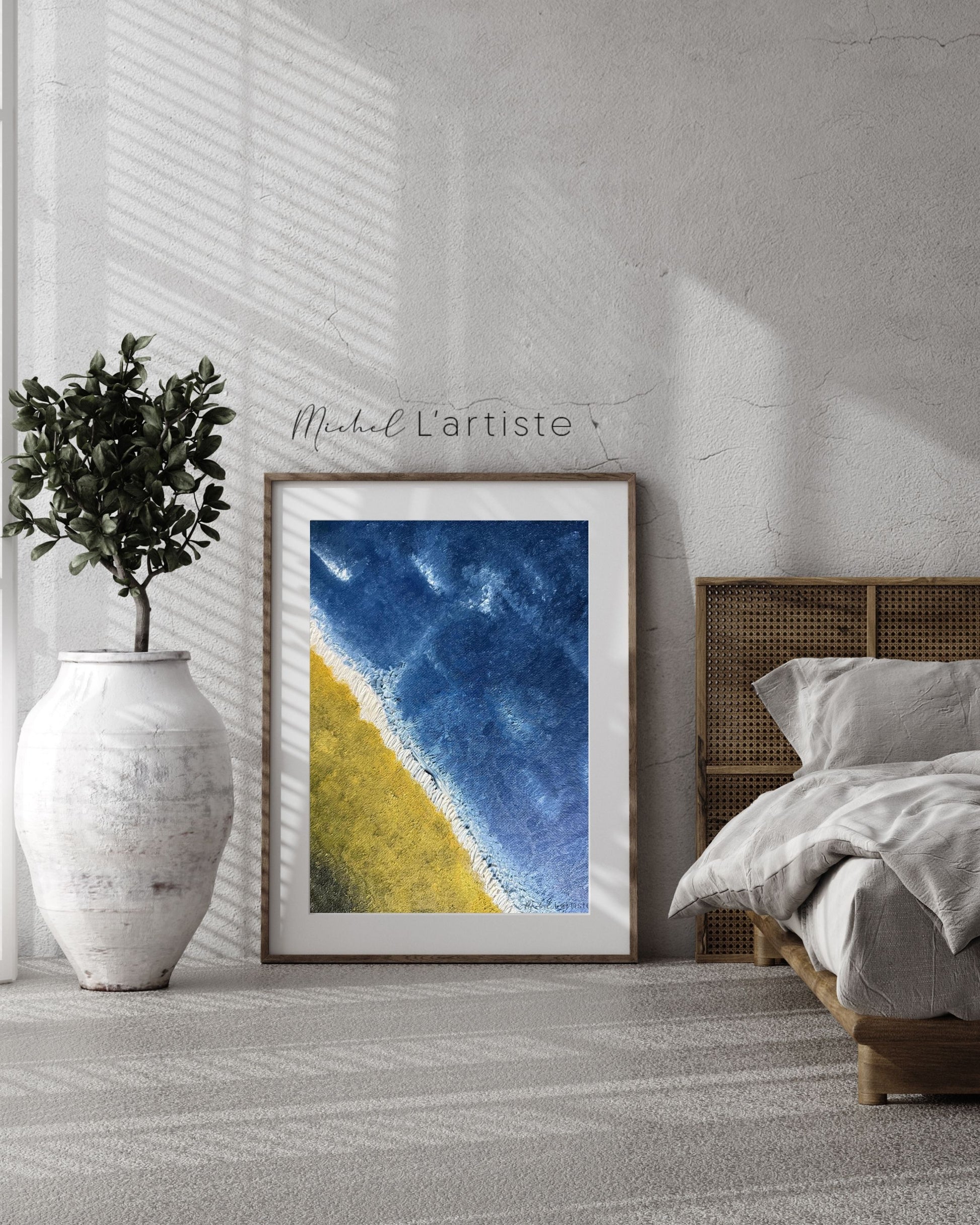 Framed artwork with blue and yellow abstract design in a bedroom setting.