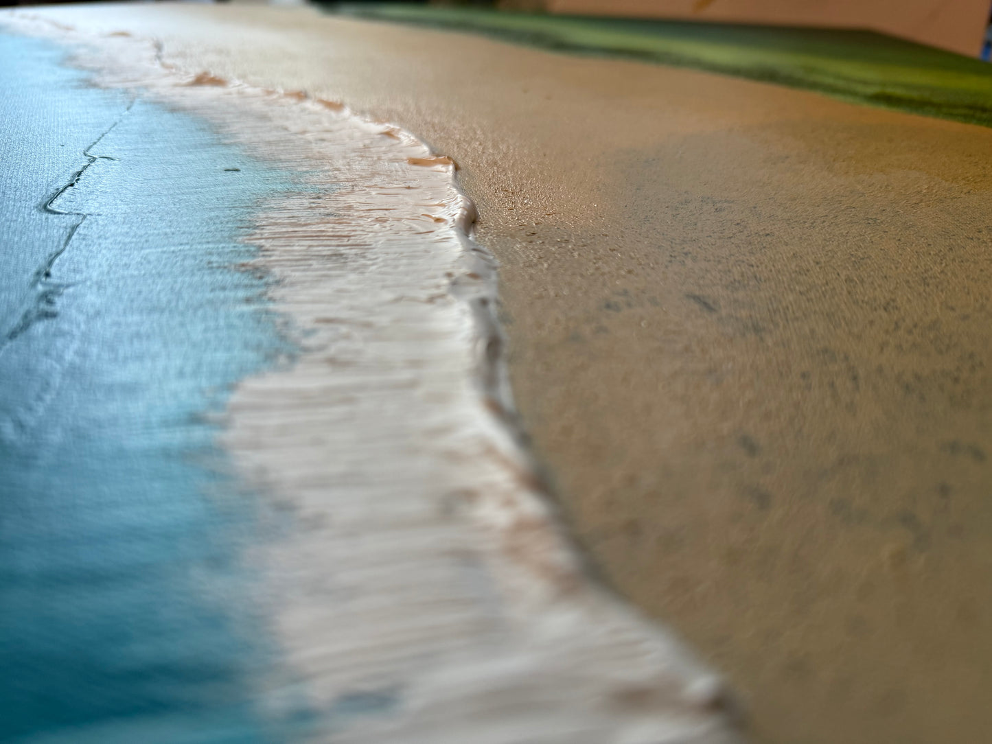 Close-up of a beach with sand and water meeting.