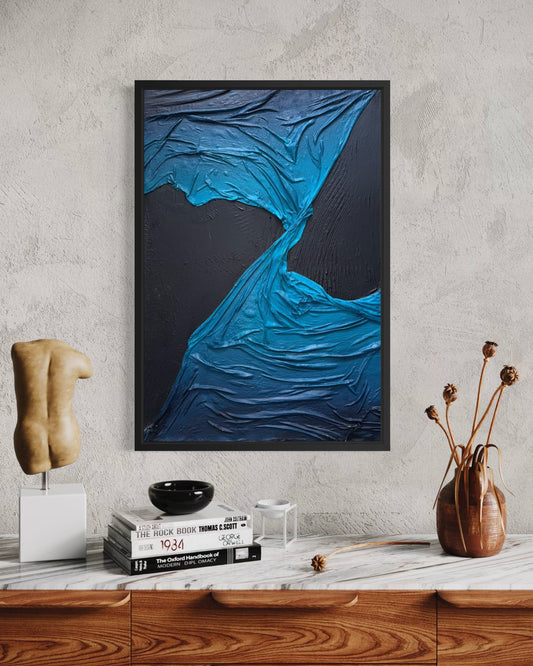 Abstract blue artwork on a gray wall above a wooden cabinet with decorative items. Twist By Michel L'Artiste