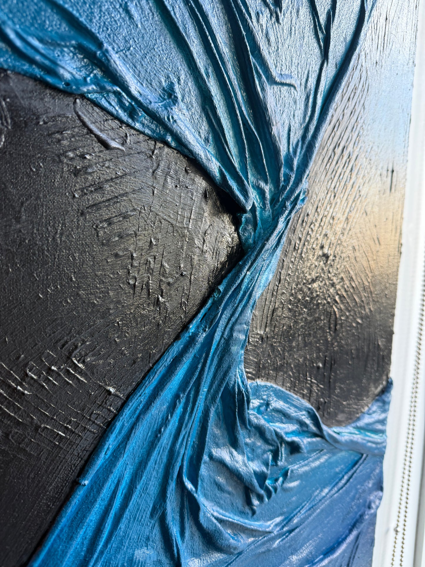 Close-up of a black surface with blue cloth wrap